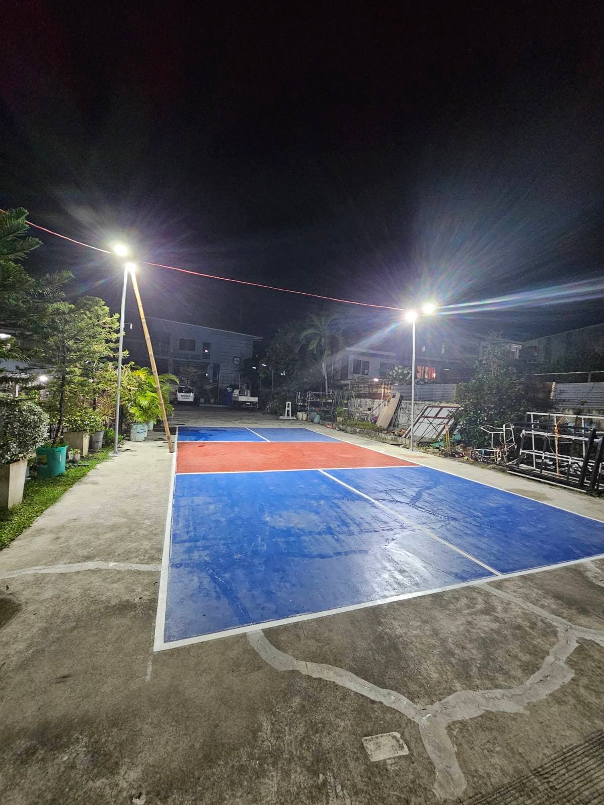 Court 2 — the outdoor pickleball court, net strung up, under an open sky
