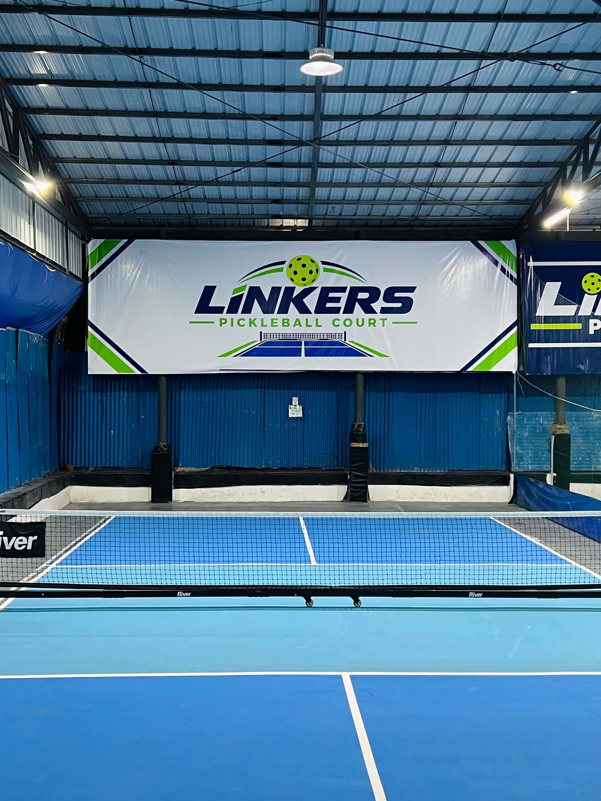 Court 3 — blue pickleball court under the covered steel-roofed pavilion